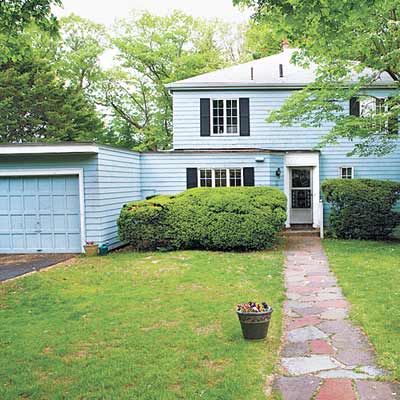house with mismatched garage with flat roof