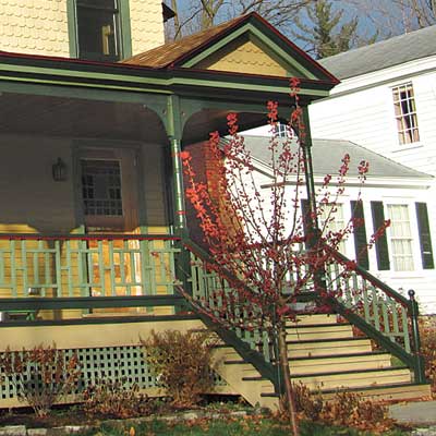 repainted stick style house with curb appeal and welcoming entry