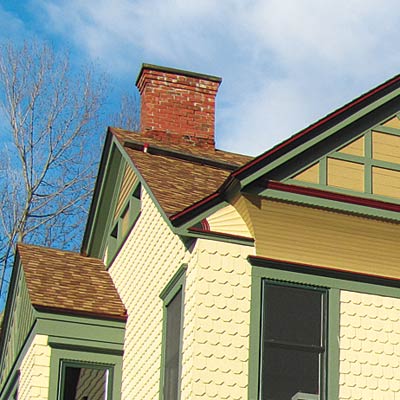repainted stick style house with curb appeal and refined roofing