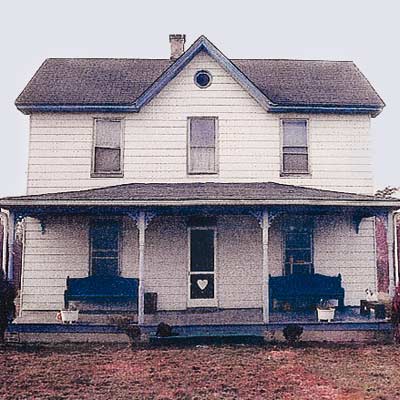 unfinished farmhouse with little curb appeal