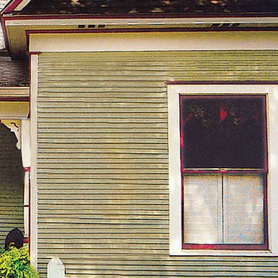 remodeled folk victorian house with curb appeal and pale green siding
