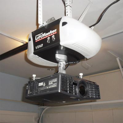 projection TV mounted to the bottom of a garage door opener