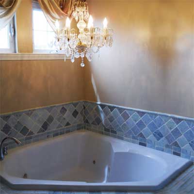 large electrical chandelier hanging directly over whirlpool bath