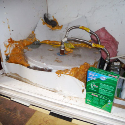Water heater installed under kitchen sink cabinet
