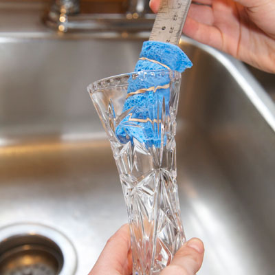 sponge attached to ruler used to dry inside of vase