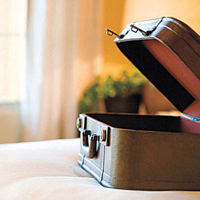 open suitcase on bed
