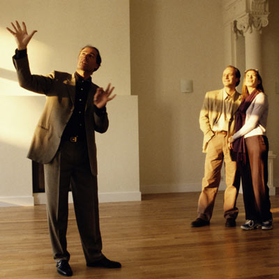 real estate broker showing house to couple