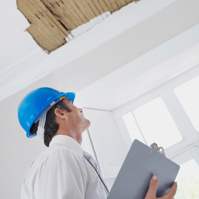 home inspector looking at stripped ceiling