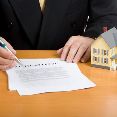 man holding home agreement and pen for signing