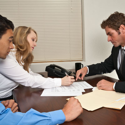 couple signing warranty with lawyer