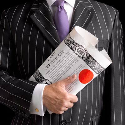 lawyer holding land deed