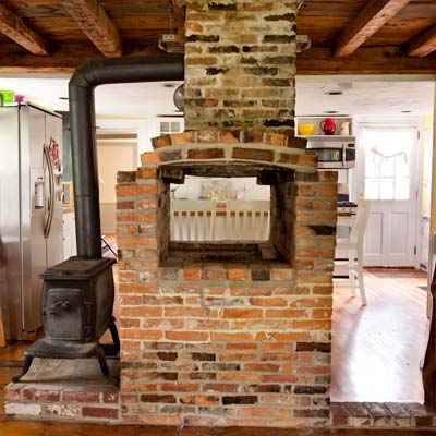 wood-burning stove and fireplace of the bedford house before this old house remodel