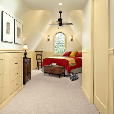a ceiling fan installed in this refinished attic 