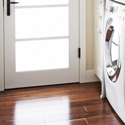 mudroom laundry room with wood flooring