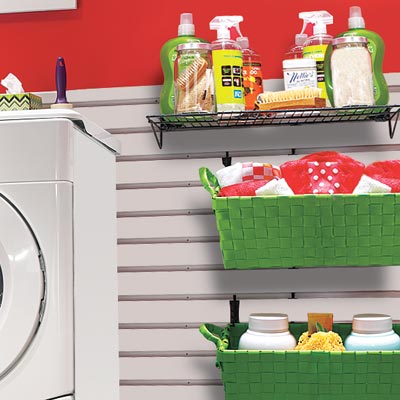 laundry room in garage with slatted wall