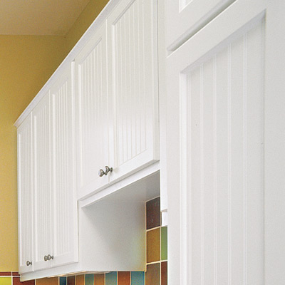 hobby space laundry room with beadboard built in cabinets