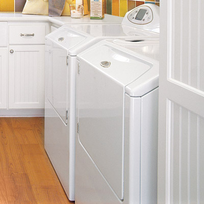 hobby space laundry room with white cabinets and white washer and dryer