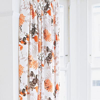 refined rustic living room with leaf print curtains