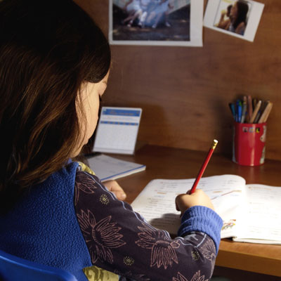 Girl doing her homework at home.