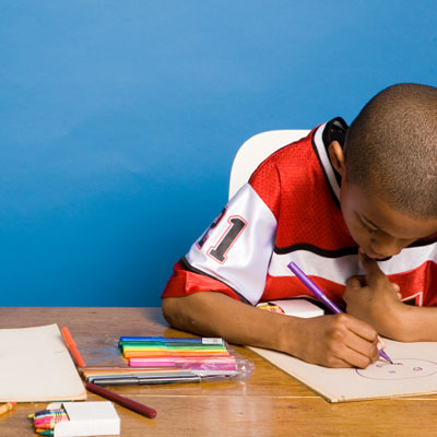 Boy coloring at a desk