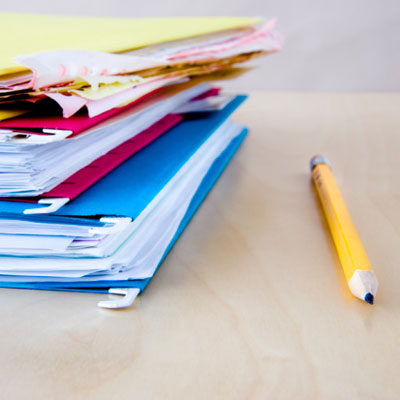 Folders and a pencil on a tabletop 