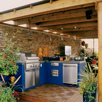 a pergola built above this beautifully designed outdoor kitchen