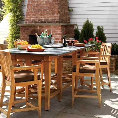 granite topped dining table as part of this beautifully designed outdoor kitchen