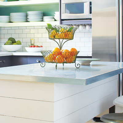 a kitchen island with a stainless steel countertop