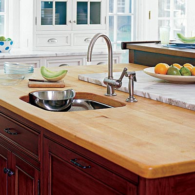 a kitchen island with a butcher block countertop