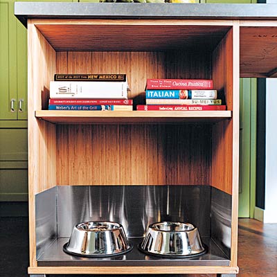 a kitchen island with an alcove for dog bowls