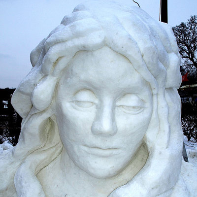 woman's head carved out of snow
