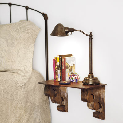 a wall shelf next to a bed