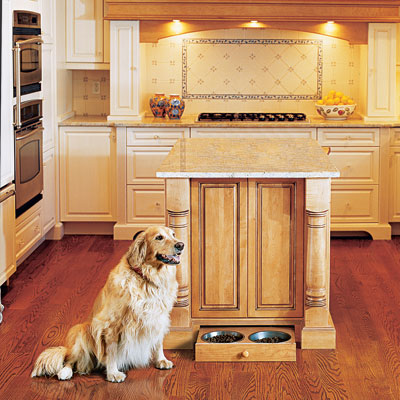 Kitchen with a pull-out pet feeder in cabinet toekick