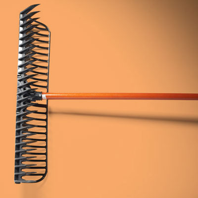 a flat steel rake with wooden handle