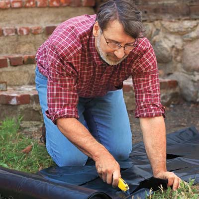 Norm Abram cutting plastic sheathing with a utility Knife