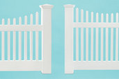 comparison shot of two vinyl picket fences from different price ranges