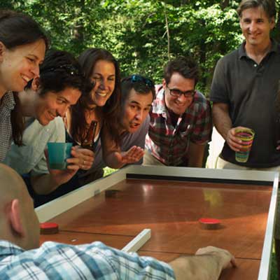 group of people playing ricochet game in backyard