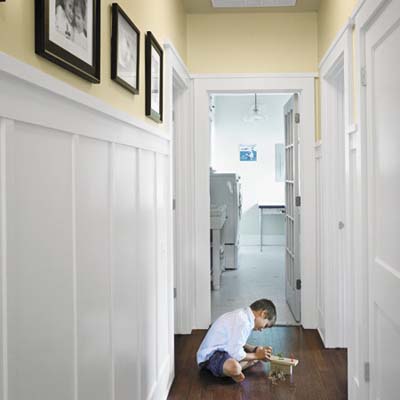 boy playing on the hardwood floor of sustainable home in Austin