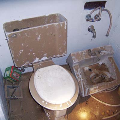 dirty dusty bathroom with with broken toilet and sink