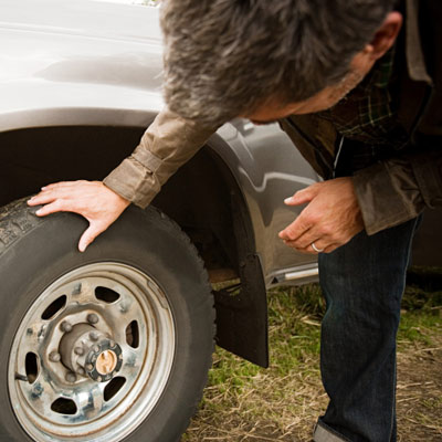 man checking his car tires