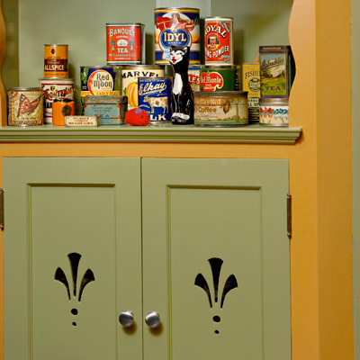 green kitchen cabinets with cutout design 
