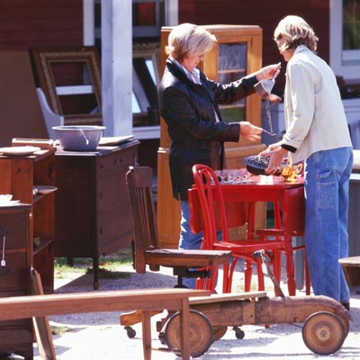 people shopping for vintage furniture at a flea market