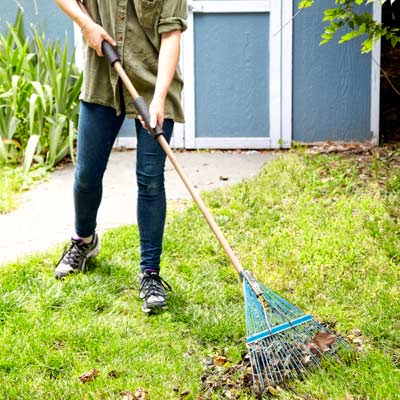 woman using pipe insulation as grip on rake handle