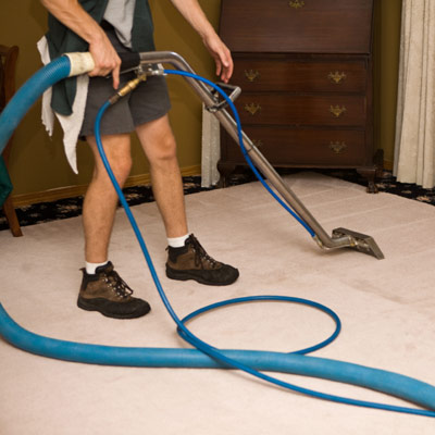 steam cleaner steaming and cleaning a carpet