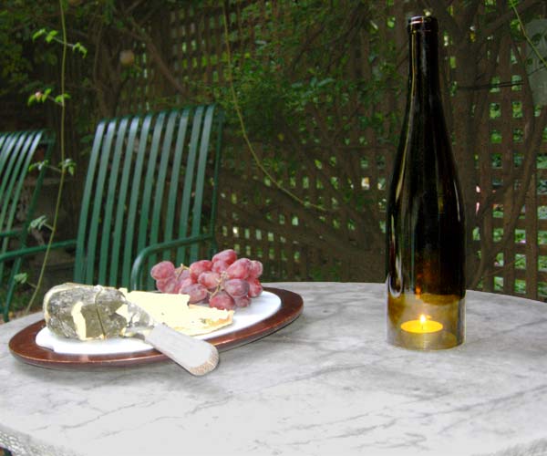 empty wine bottle used as hurricane for tea light