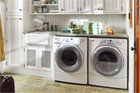 a remodeled laundry room with green towels