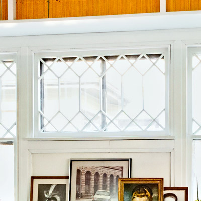 closeup of window with white trim and built-in bookshelves