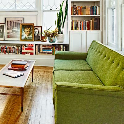 green vintage sofa and bench-style coffee table 