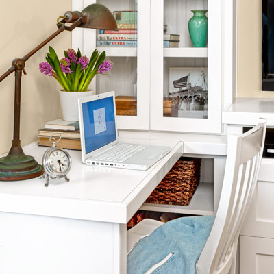 guest bedroom remodel with built-in desktop and glass doors for cabinets