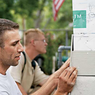 construction workers installing fiber cement siding
